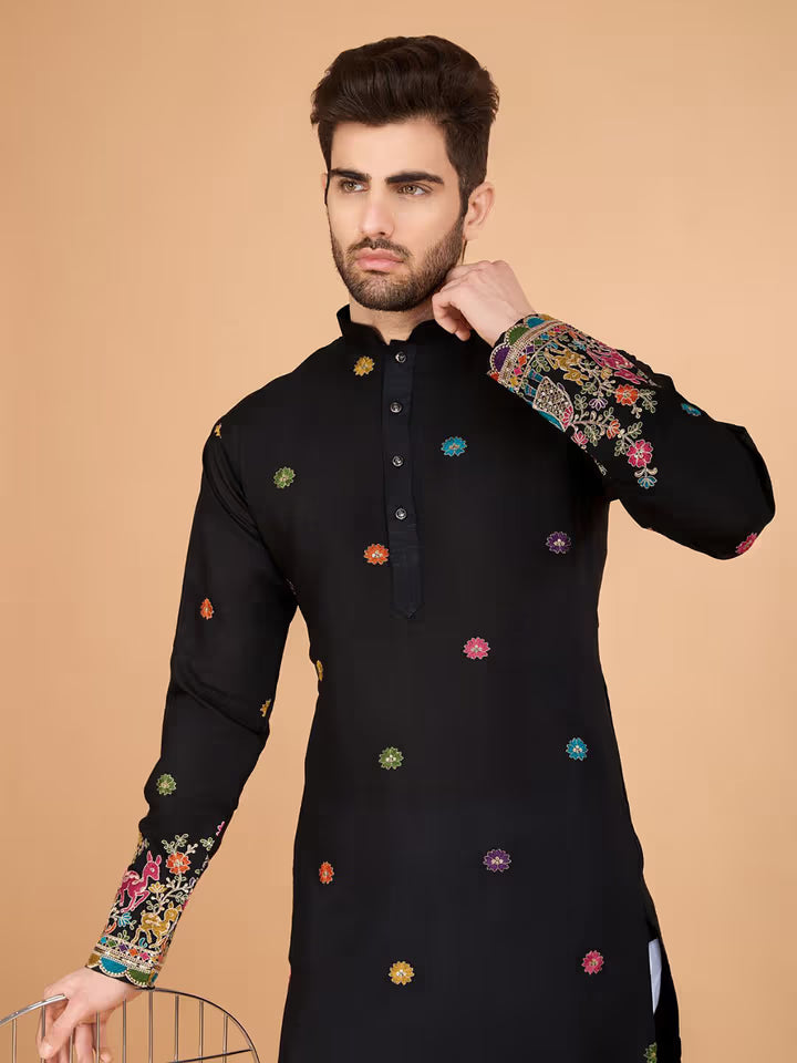 Men’s black kurta with colorful embroidery and festive border – ethnic wear for weddings and celebrations