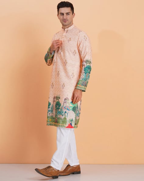 Man wearing a peach scenic printed kurta with white pants – perfect for festive and wedding occasions
