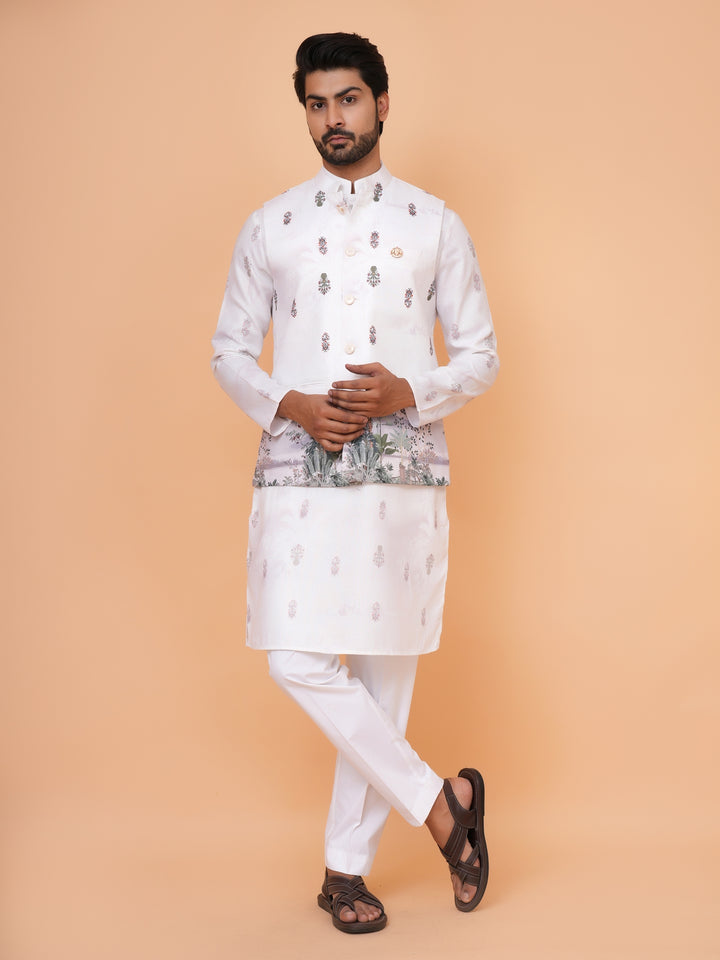 Man wearing a traditional white kurta with intricate patterns on a beige background